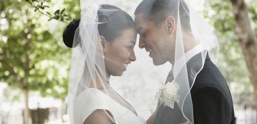 African American Bride and Groom Hugging